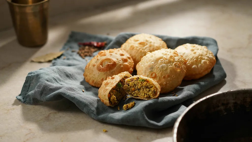 Atta kachoris with a blistered crust, one broken to show the dal filling, made with CressPure Sharbati atta