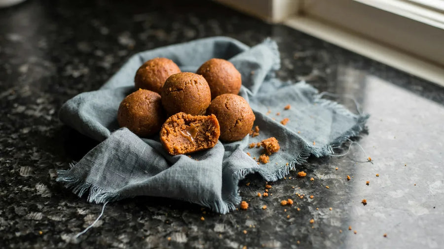 Rajasthani churma ladoos with a coarse golden crumb, one broken open, made with CressPure Sharbati atta