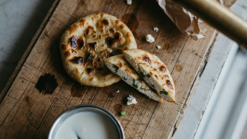 Paneer paratha cut to show an even layer of crumbled paneer, made with CressPure Premium Sharbati Atta