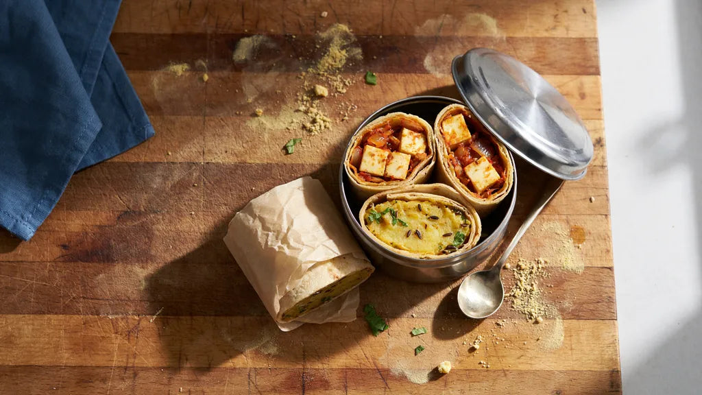 Roti rolls with paneer and aloo fillings packed in a steel tiffin, made with CressPure Sharbati atta