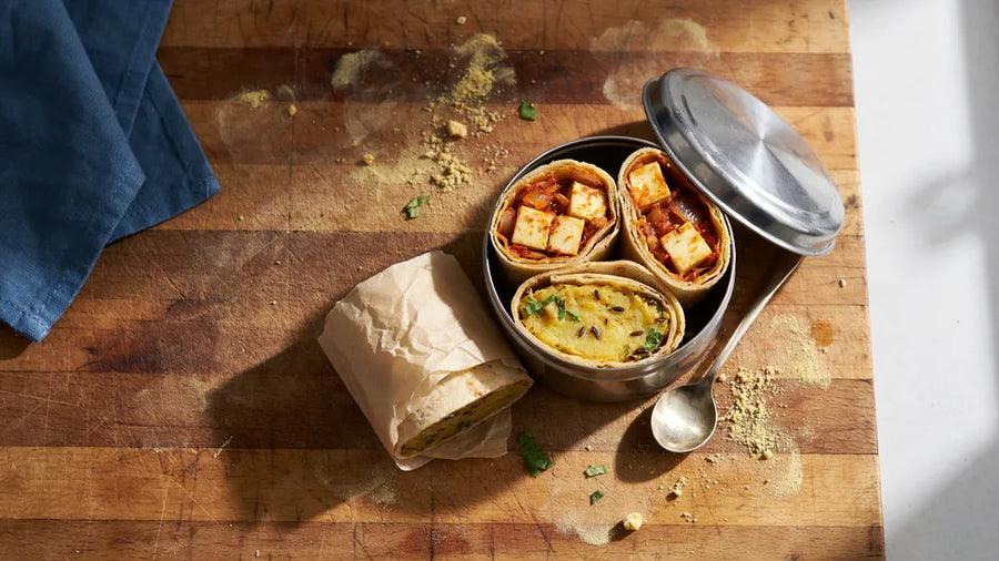 Roti rolls with paneer and aloo fillings packed in a steel tiffin, made with CressPure Sharbati atta