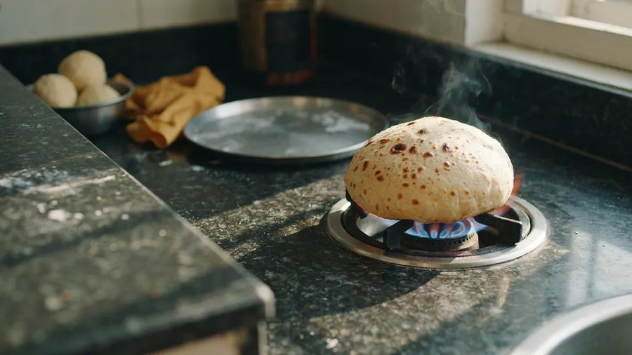A wholewheat phulka puffed into a full round dome over a gas flame, made with CressPure Sharbati atta