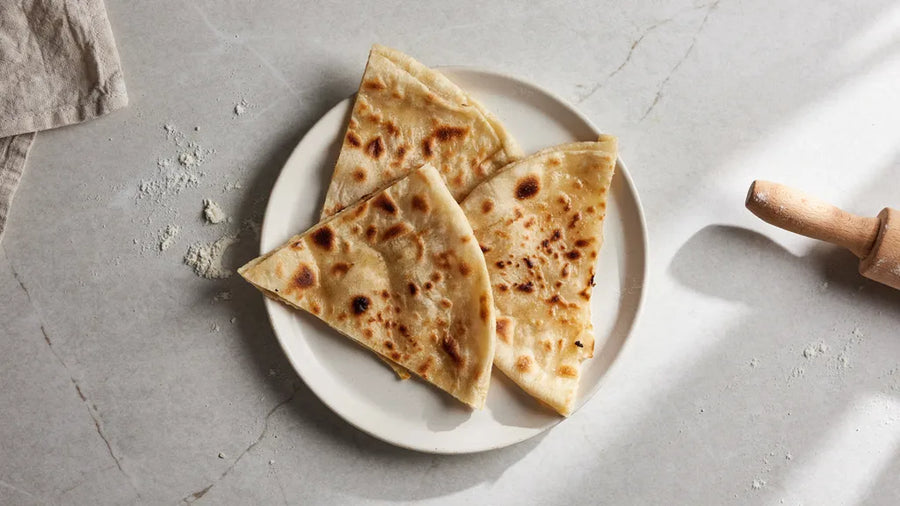Triangular tawa parathas with visible folded layers, made with CressPure Premium Sharbati Atta