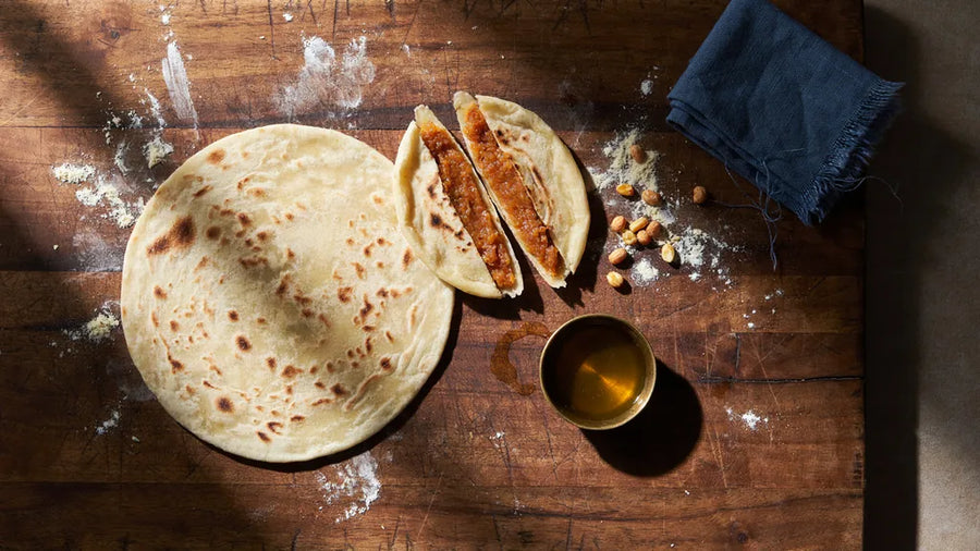 Puran poli with a thin golden skin torn to show the chana dal and jaggery filling, using CressPure atta